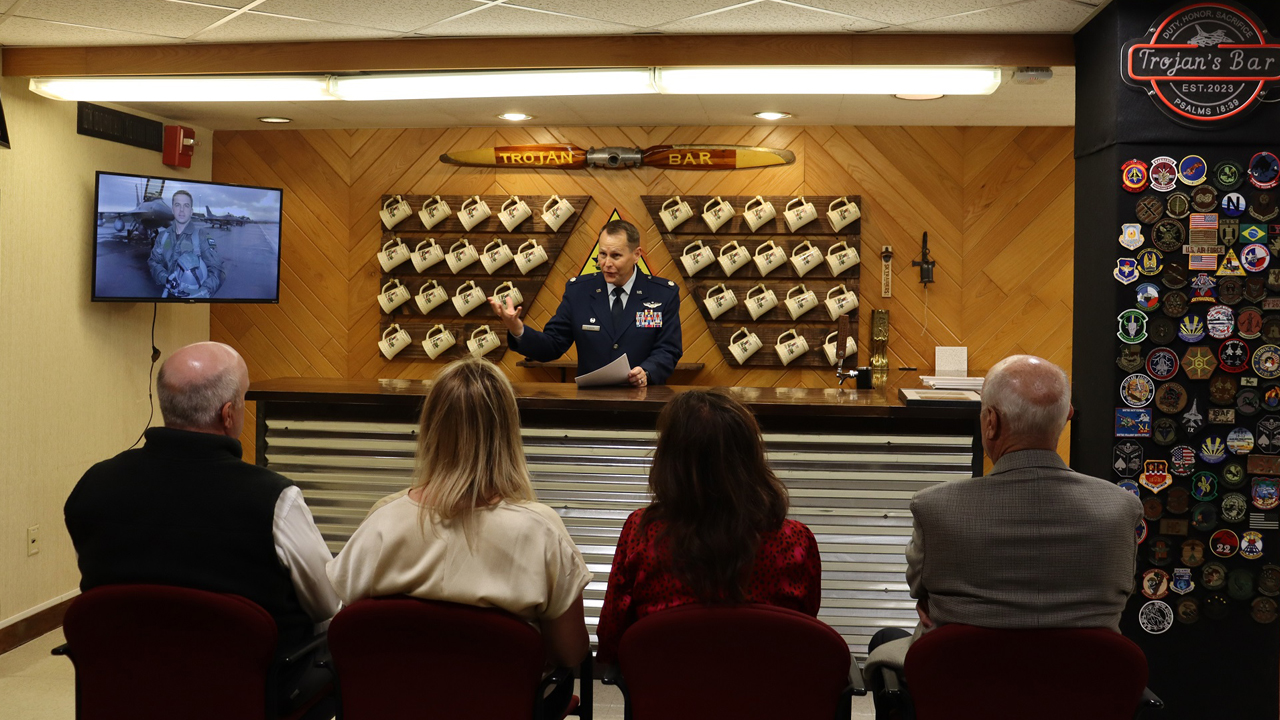 Air Force ROTC Detachment Commander Lt. Col. Daniel O’Brien delivers remarks at the dedication ceremony for the new ‘Trojan Bar,’ Nov. 17, 2023, at Texas Tech University, Lubbock, Texas. The detachment dedicated a heritage room in honor of Maj. Troy ‘Trojan’ Gilbert, a Texas Tech alum and F-16 pilot who lost his life while executing a low-level strafing pass during Operation Iraqi Freedom in 2006. The university also unveiled a commemorative plaque in its Memorial Circle to honor Gilbert as part of its centennial celebration. (U.S. Air Force photo by Cadet Kendall Jones)