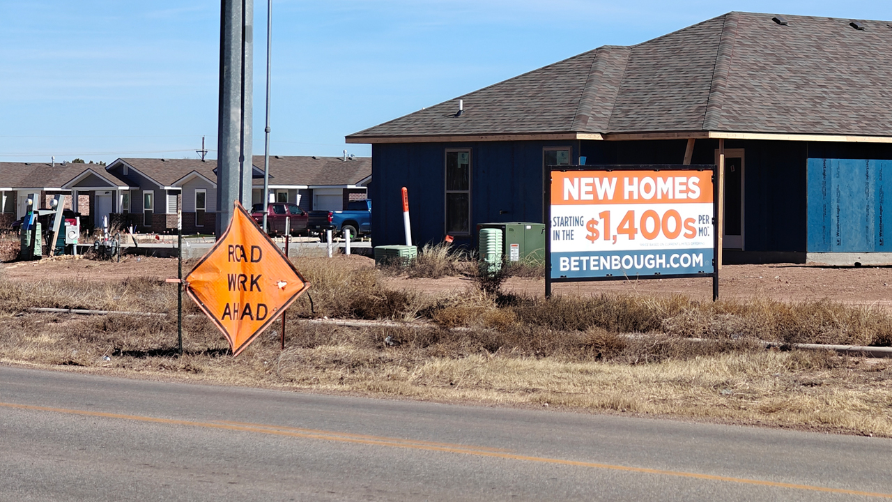 New homes next to road that will soon be under construction in Lubbock, Texas